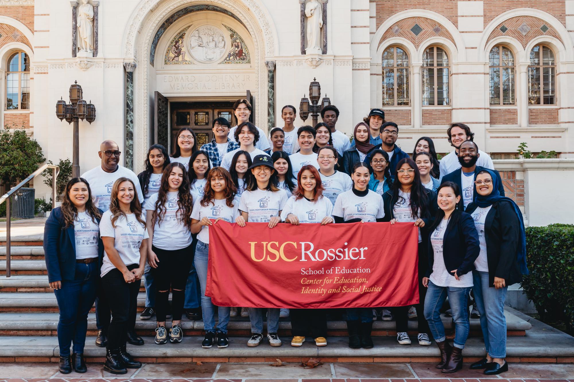 A group of students with a banner that reads: "Center for Education, Identity and Social Justice"