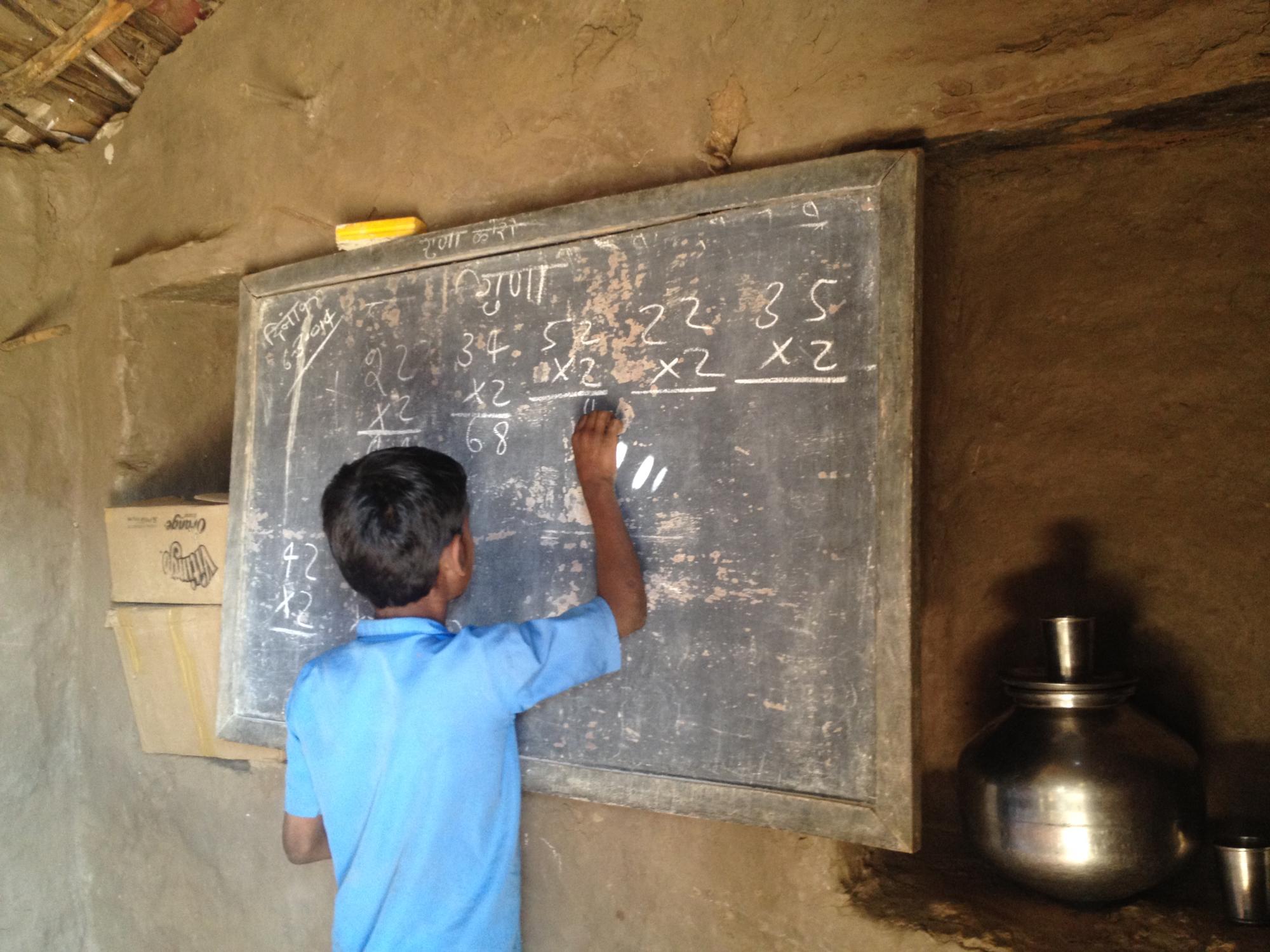A student at a school solving math problems in Udaipur, India