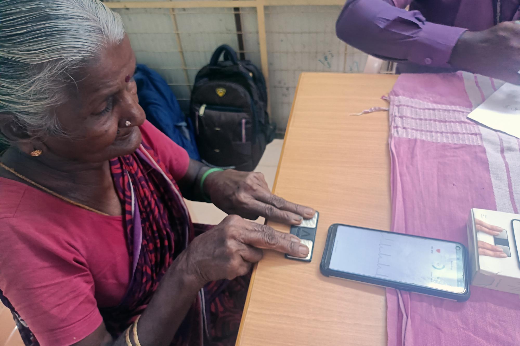 Elderly women uses index fingers for an ECG test
