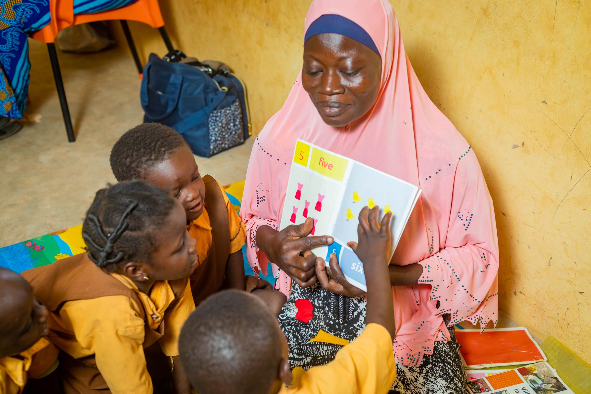 Teacher teaching children in a classroom in Ghana