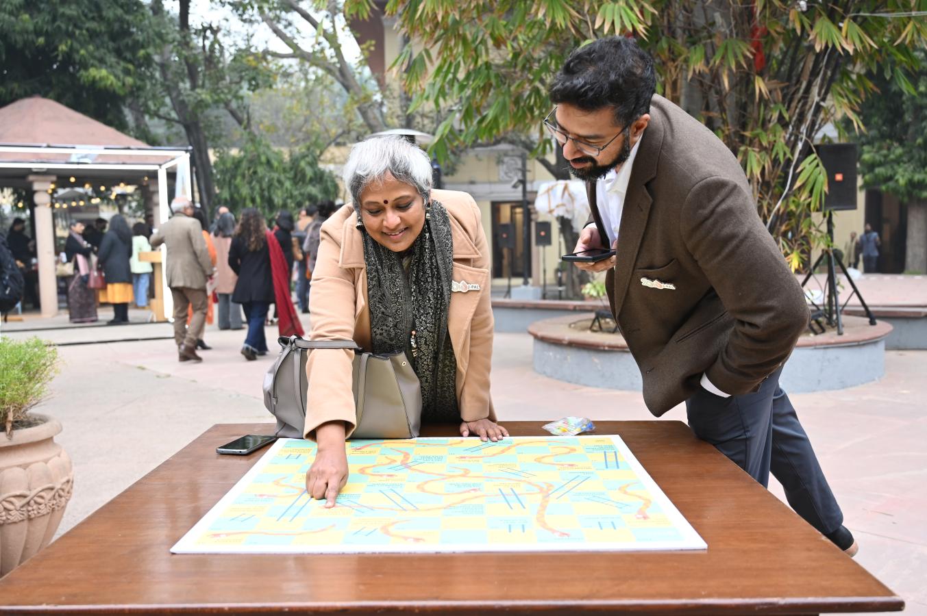 A man and woman point at a map