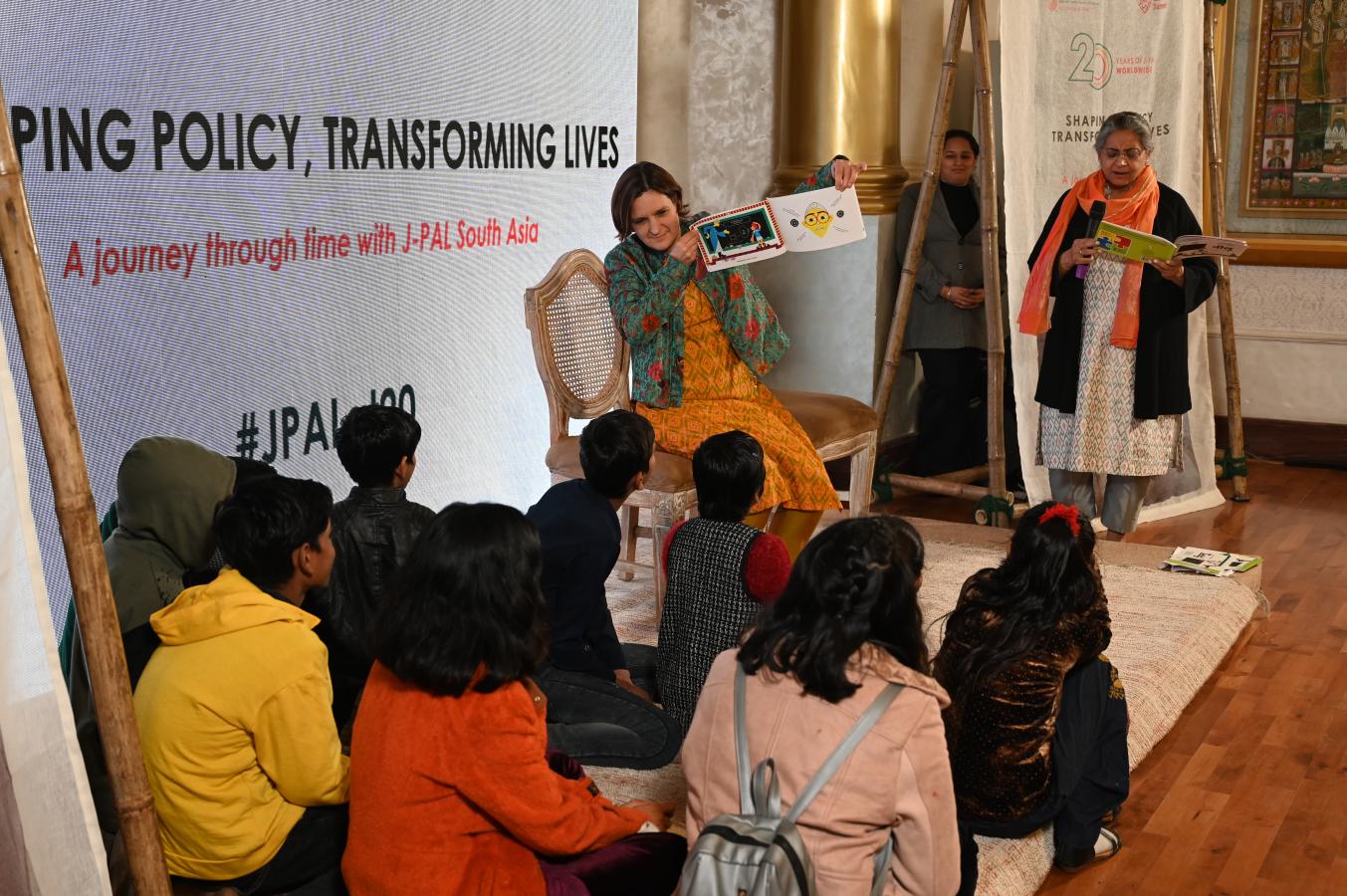 A woman reads a story to children.