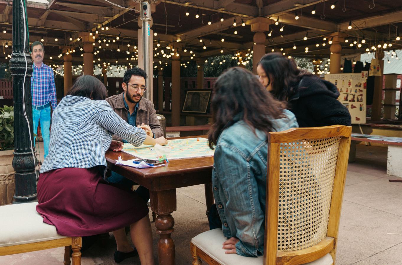 A group of people playing snakes and ladders