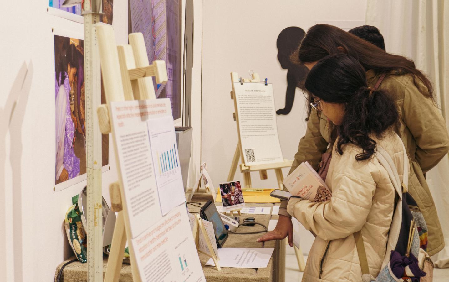 Women looking at cards in an exhibit