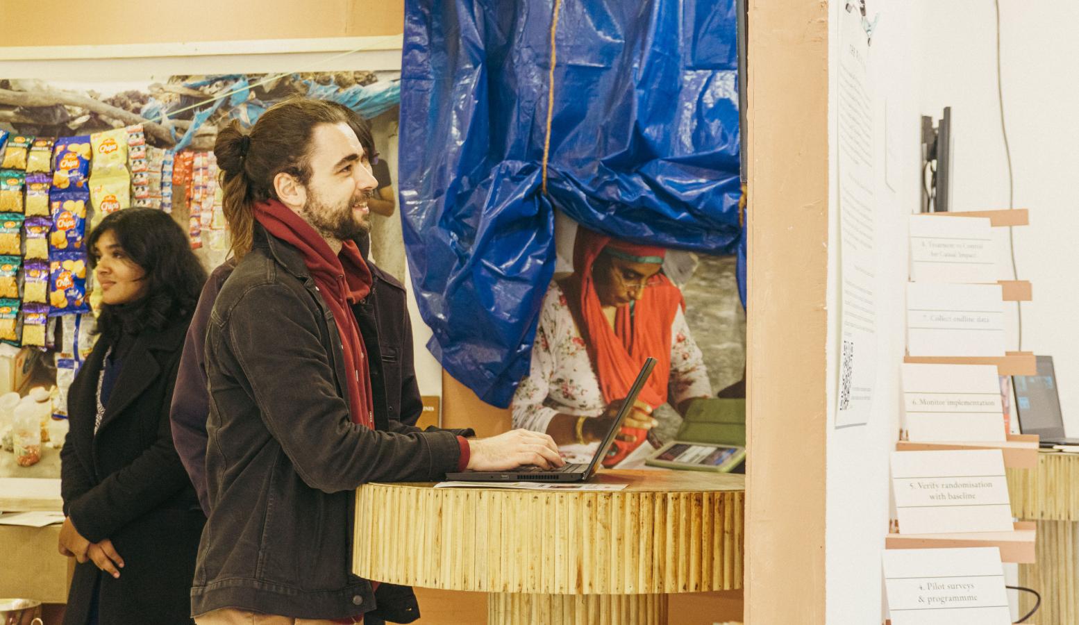 A man using a laptop in an exhibit