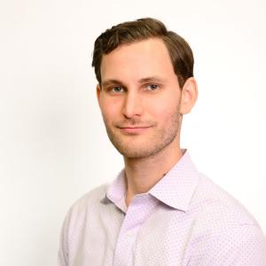 A headshot of Michael Smith in front of a white background.