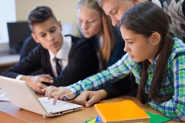 Students collaborate on laptop