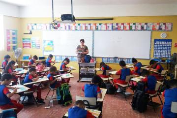 Young students do schoolwork in a classroom in Puerto Rico