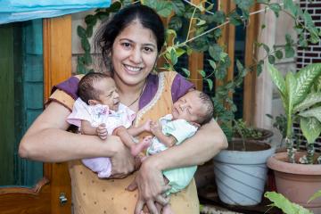 mother holding twin babies