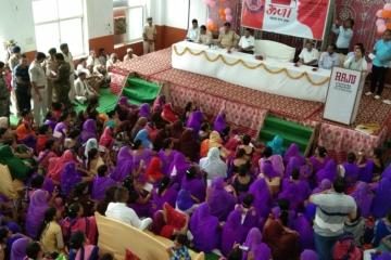 Women attend a community outreach session on women's help desks.