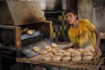 A young man works in a bakery in Egypt. 