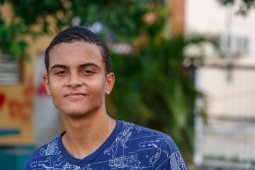 Male teenage student walks home from school in the Dominican Republic