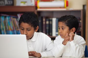 Students working together on a laptop.