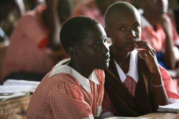 Girls in school uniforms sit in class