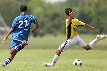 Two boys playing soccer 