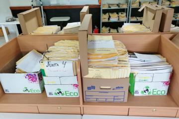 Cardboard boxes filled with paper files