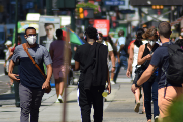 People walking in the street with masks on