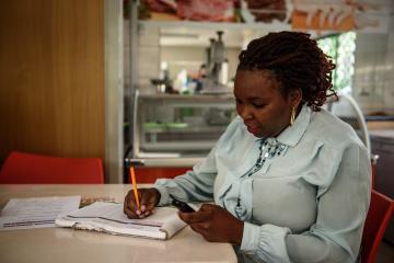 A woman completes a digital cash transfer