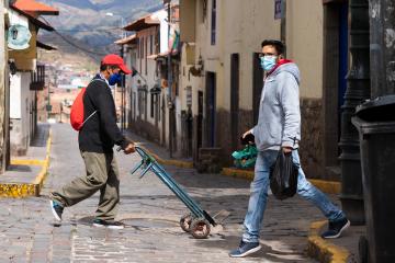 Men walking on the street wearing masks