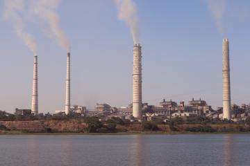 Smoke stacks billowing smoke in India