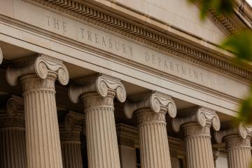 Close-up shot of the US Department of Treasure columns and roof