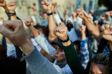 Large group of people with raised fists