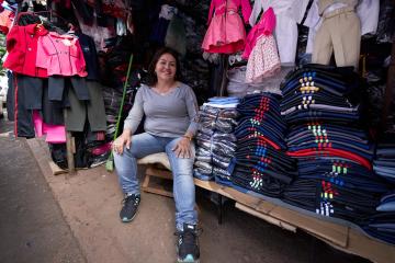 Paraguayan saleswoman in front of clothing market