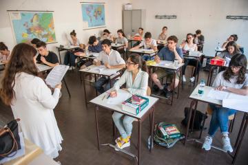 Students sitting at desks for first day of high school exams at Vittorio Alfieri state high school in Turin