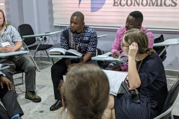 Students sitting as desks at J-PAL Africa’s 2022 Evaluating Social Programs course at the African School fof Economics in Abuja, Nigeria