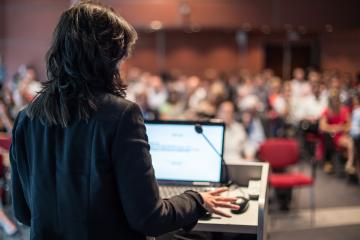 Women speaks in front of room