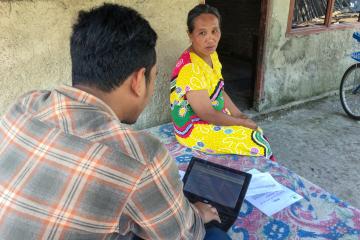 Zeqi Yasin interviewing a respondent for an evaluation in Indonesia. 