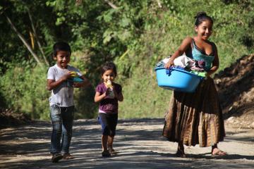 Young woman and two kids walking