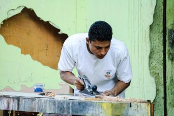 A man using a saw