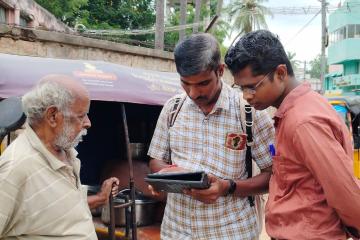 Government surveyor accompanied by J-PAL supervisor administering the Panel Survey Wave 2 to an elder in Trichy