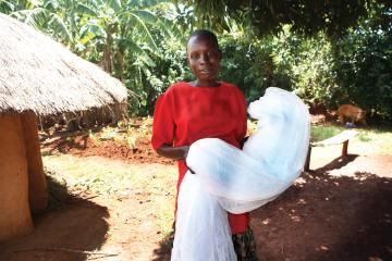 A woman holding a bednet