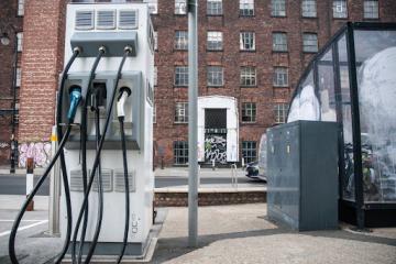 Electric car charging point with urban backdrop