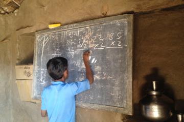 A student at a school solving math problems in Udaipur, India