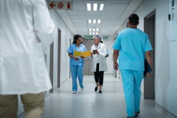 Doctor and nurse walking down hospital hallway
