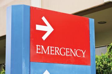 Sign pointing towards emergency room